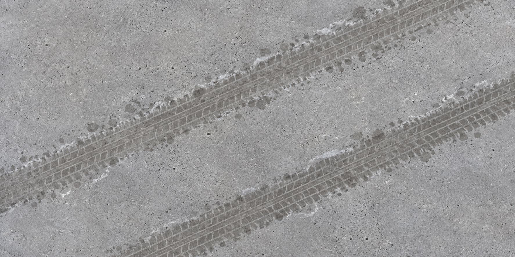 Concrete garage floor with tyre tracks and road-salt residue